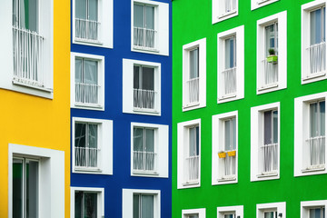 Colored facades of residential buildings in the colors yellow, blue and green