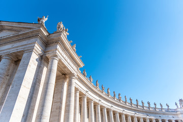 Doric Colonnade with statues of saints on the top. St. Peters Square, Vatican City - obrazy, fototapety, plakaty