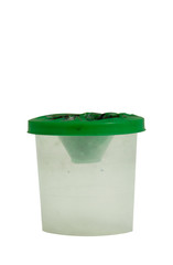 Non-spill with a green lid for painting with water-soluble paints. Cup for water and brushes. Artistic theme. Isolated object on white background.