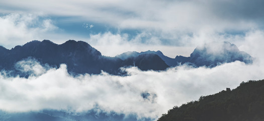 Fototapeta premium Cloudy mountains panorama.