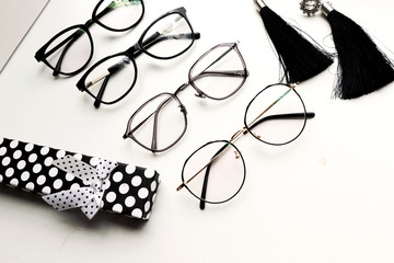 Stylish women's glasses on white background, optics store. Minimalism flat lay.