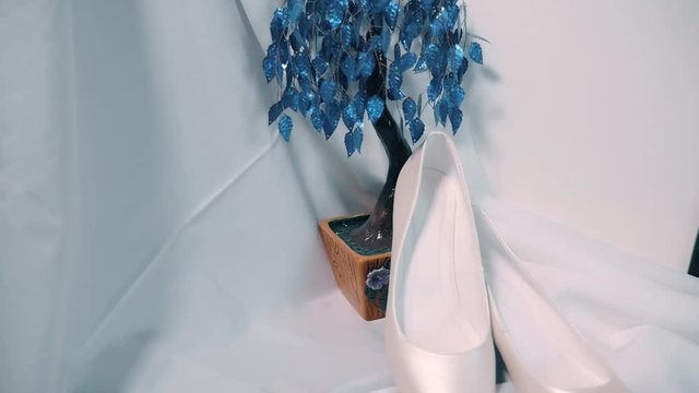Bride's wedding shoes and decorative flower