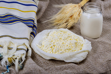 Kosher cheese cottage and milk on wheat wood background. jewish holiday shavuot