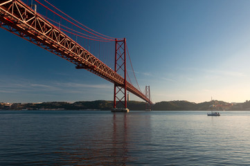 Scenic view of the 25 of April Bridge (Ponte 25 de Abril) over the Tagus River in the city of Lisbon, Portugal; Concept for travel in Portugal