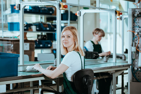 Pretty Female Student Wearing Green Overall Doing Practical Work At Factory