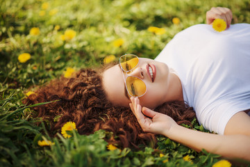 Outdoor flat lay, top view close up portrait of young beautiful happy smiling woman with long curly...
