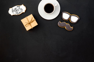 design for Father Day celebration party with cookies, gift box and coffee on black background top view mock up