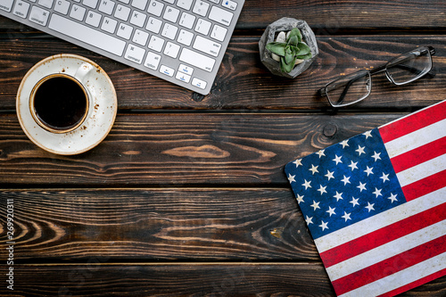 Memoral day of United States of America with flag, keyboard, glasses and coffee on wooden background top view mockup