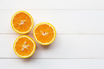 Orange citrus fruit on white wooden