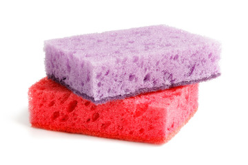 Obraz na płótnie Canvas Colored sponges for washing dishes and other domestic needs. Purple sponge lies on a red sponge at a slight angle. Isolate