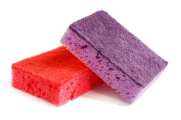 Colored sponges for washing dishes and other domestic needs. Purple sponge lies on a red sponge at a slight angle. Isolate