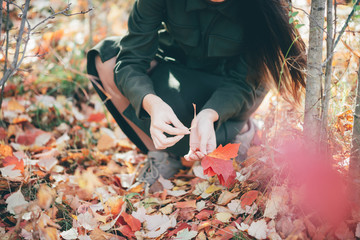 Dreamy beautiful girl with long natural black hair on autumn background with colorful leaves in...