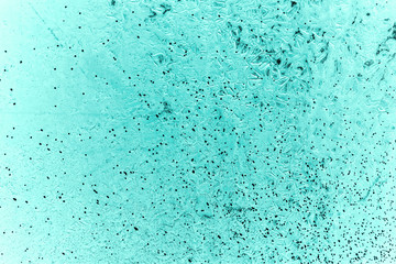 Vintage azure background. Rough painted wall of turquoise color. Imperfect plane of cyan colored. Uneven old decorative toned backdrop of aqzure tint. Texture of teal hue. Ornamental stony surface.