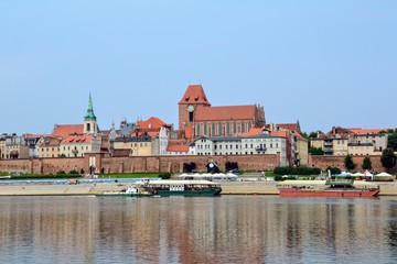 Obraz premium Panoramic view od old town in Torun, Poland, on Vistula bank. Historical district of Torun old town by the Vistula river