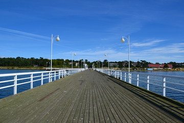 Wooden pier in Jurata town at sunny, summer day. Coast of Baltic Sea at Hel peninsula, Poland
