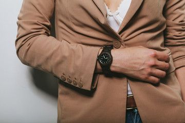 The girl in a jacket with a clock on her hand