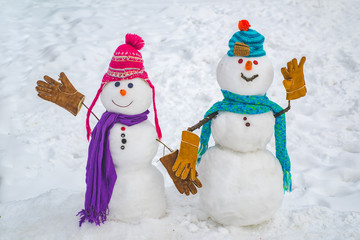 Two Snowman on snow background. Snowman couple in love have fun Christmas or New Year. Happy new year snowman friends. Trust in love. Romantic and love - winter concept. I love you.