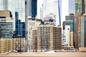 (Selective focus) Close-up view of the Manhattan skyline seen from the beautiful Brooklyn bridge in Manhattan, New York City, USA.