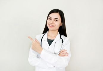 Portrait of an attractive young female doctor in white coat. 