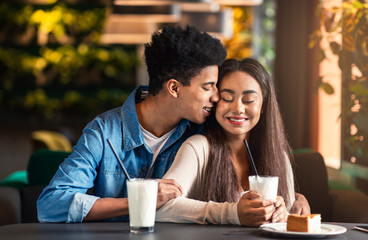 Teen black couple in love dating in cafe