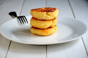 Cheesecakes on a white plate, on a white background.