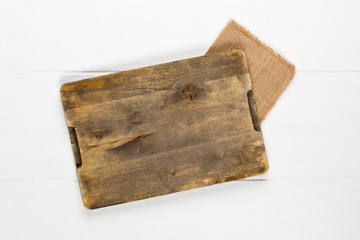 Empty cutting board on rustic white wooden table background top view from above