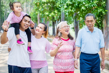 Happy three generation family stands at outdoors