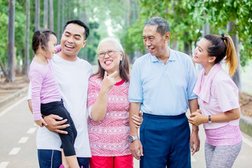 Little girl chats with her family in the park