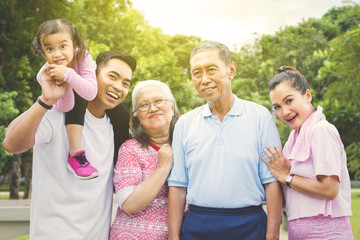 Multi generation family smiling in the park