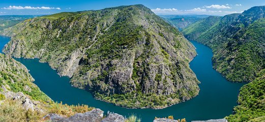 Fototapeta na wymiar Panoramic of an impressive viewpoint of the Sil Canyon in the Ribeira Sacra, Galicia. From it you can see a beautiful meander of the Sil river.
