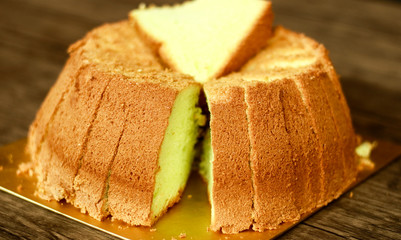 Pandan chiffon cake on wood background. 