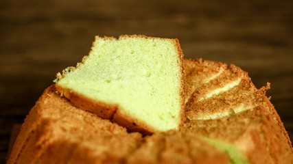 Pandan chiffon cake on wood background. 