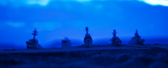 Fototapeta na wymiar Military navy ships in a sea bay at sunset time. Selective focus