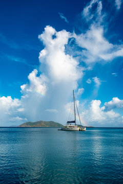 A sail boat anchored in the bay