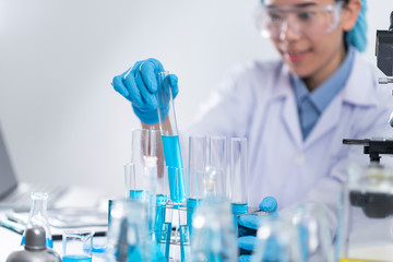 Researchers are using glassware and blue solutions in laboratories, research on cosmetics and energy.