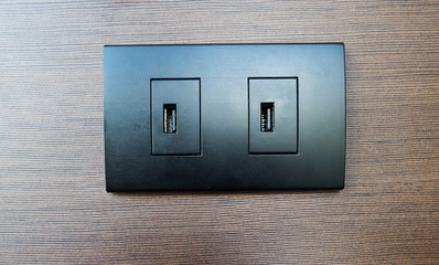 USB socket port with USB on wooden wall background