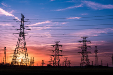 Fototapeta premium Silhouette of Power Supply Facilities at Sunset
