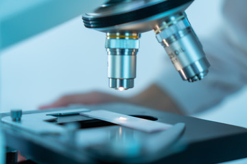 Close-up shot of microscope with metal lens at laboratory.