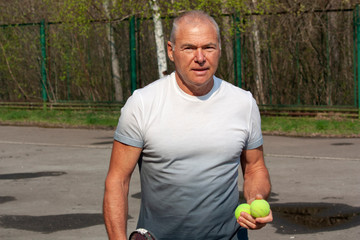 Naklejka na ściany i meble Man playing tennis on the outdoor court
