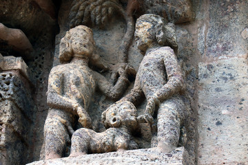 Fototapeta na wymiar Konark Sun Temple in Odisha, India. Erotism and origin of kamasutra in Indian sculpture. Erotic sculpture of Konark temple.