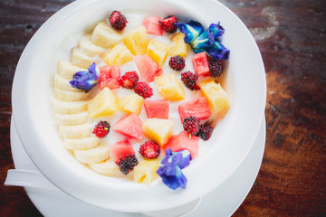 fresh tropical fruit dressing on yougurt milk morning fod meal