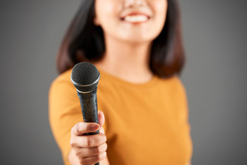 Woman giving young microphone