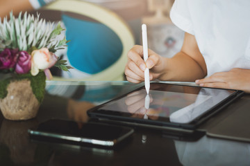 Closeup of female hand using tablet create and design job