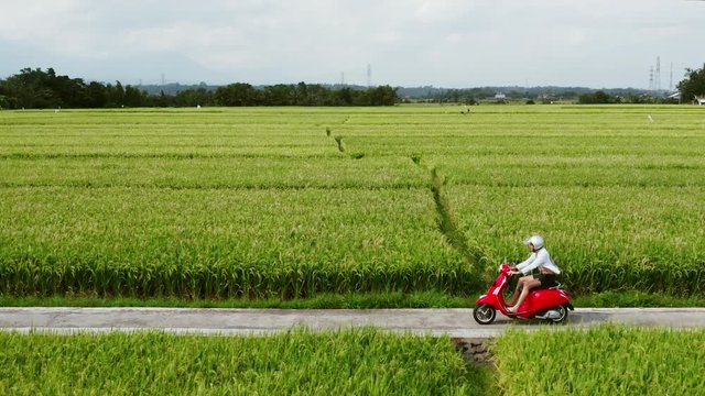 A young man riding a chopper on a countryside road. Beautiful mountain road. travel on motorbike.