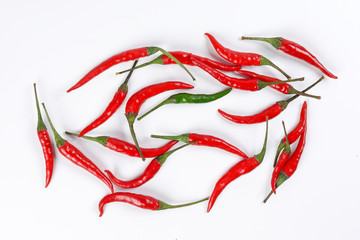 Fresh birds eye red chilli scattered isolated unique green chilli top view on white background