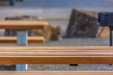 Fototapeta na wymiar Close up of a light brown wooden table with benches at a park