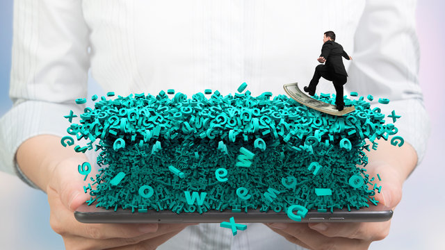 Big data concept. Woman hands holding smart tablet with surfing business man riding dollar bill surfboard on tsunami wave of computer data, huge amount of numbers and letters, front view.