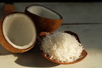 Grated Coconut and Half cut coconut on wooden floor
