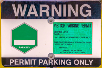 Close up view of a Warning Permit Parking Only sign board