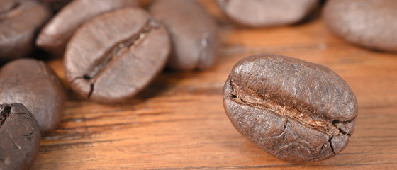Close up of coffee beans on wooden background